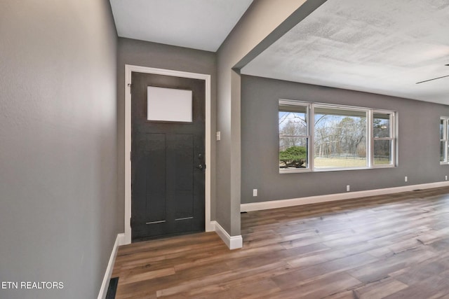 entryway featuring wood finished floors, visible vents, and baseboards