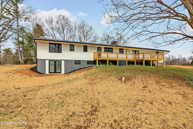 back of property featuring a deck, french doors, and a chimney