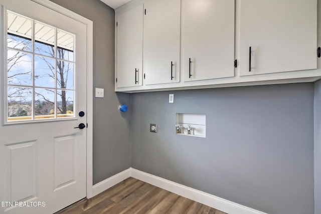 washroom with dark wood-style floors, hookup for a washing machine, cabinet space, electric dryer hookup, and baseboards