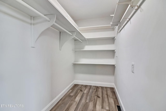 spacious closet with wood finished floors and visible vents