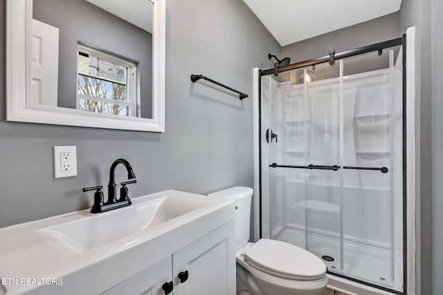 full bath with a shower stall, toilet, and vanity