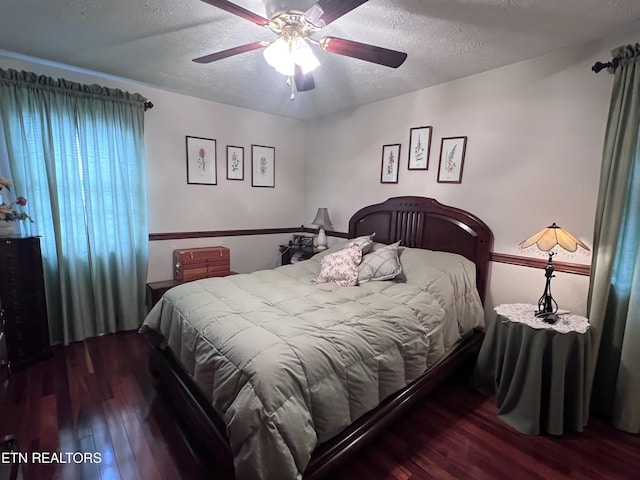 bedroom with a ceiling fan, a textured ceiling, and wood finished floors