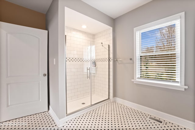 full bathroom with tile patterned flooring, visible vents, a shower stall, and baseboards