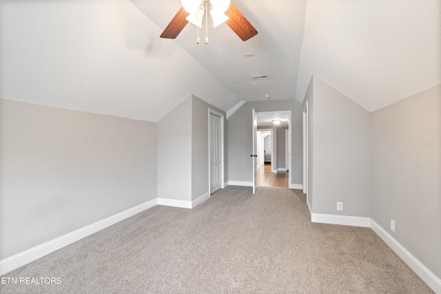 bonus room with visible vents, baseboards, a ceiling fan, vaulted ceiling, and carpet flooring