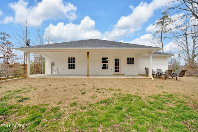 rear view of property featuring a patio area and fence