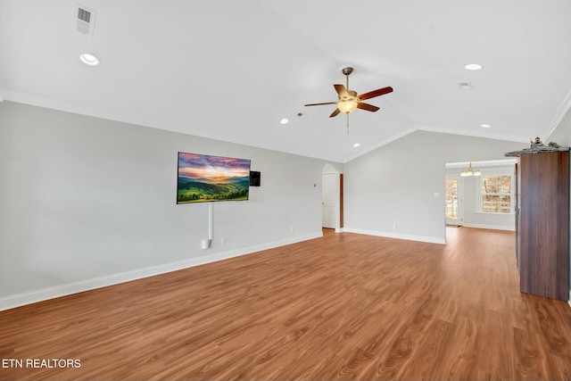 unfurnished living room featuring lofted ceiling, visible vents, baseboards, light wood finished floors, and crown molding