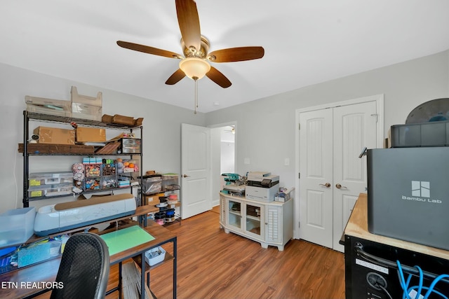 office space with a ceiling fan and wood finished floors