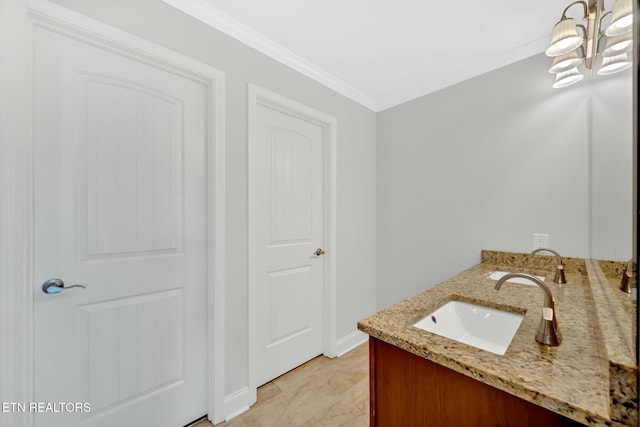 bathroom featuring crown molding, vanity, and an inviting chandelier