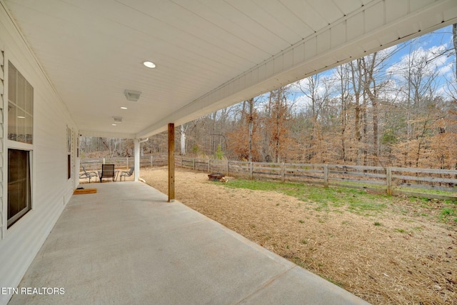 view of patio / terrace with a fenced backyard and a wooded view