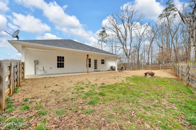 back of property featuring a fenced backyard, a patio, and a lawn