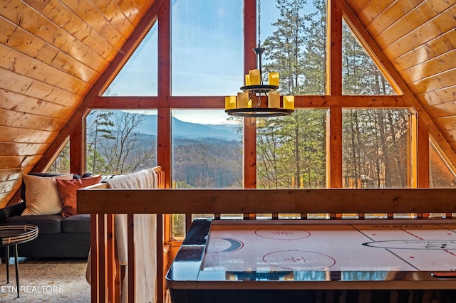 interior space featuring wooden ceiling, vaulted ceiling, and a mountain view