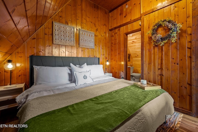 bedroom with wooden ceiling and wooden walls