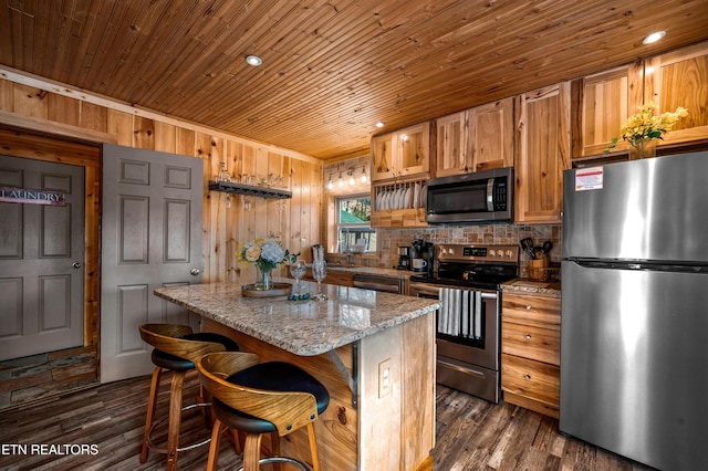 kitchen with stainless steel appliances, dark wood-style flooring, wooden ceiling, and a center island