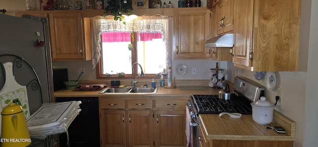 kitchen featuring black dishwasher, light countertops, a sink, stainless steel gas range, and under cabinet range hood