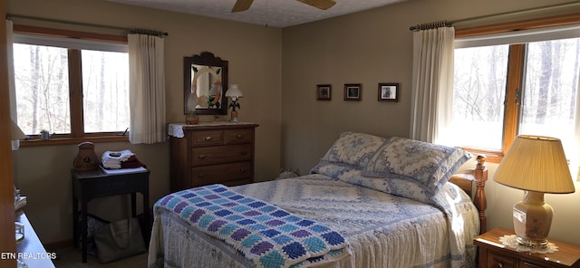 bedroom featuring multiple windows and a ceiling fan