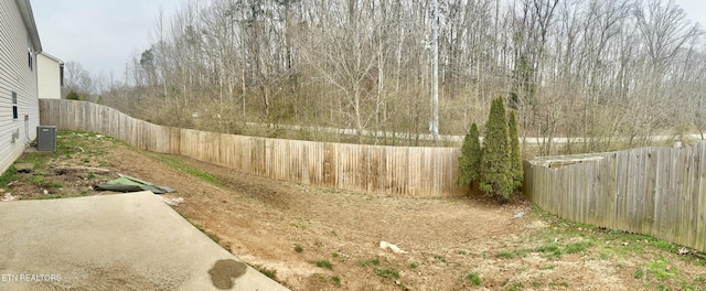 view of yard featuring central air condition unit and a fenced backyard