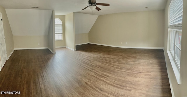 additional living space featuring a ceiling fan, vaulted ceiling, wood finished floors, and baseboards