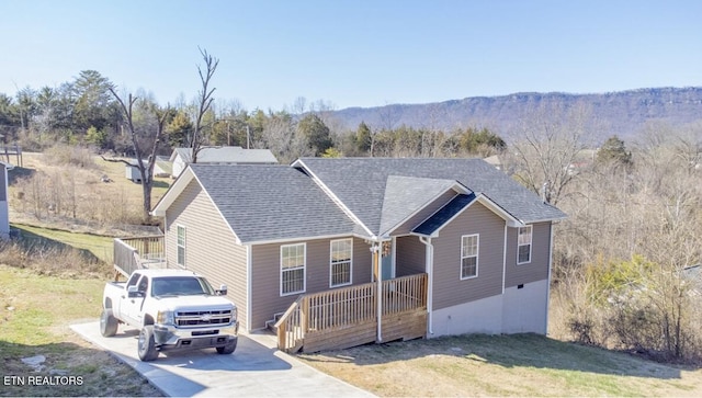 ranch-style house with a front yard, a porch, and roof with shingles