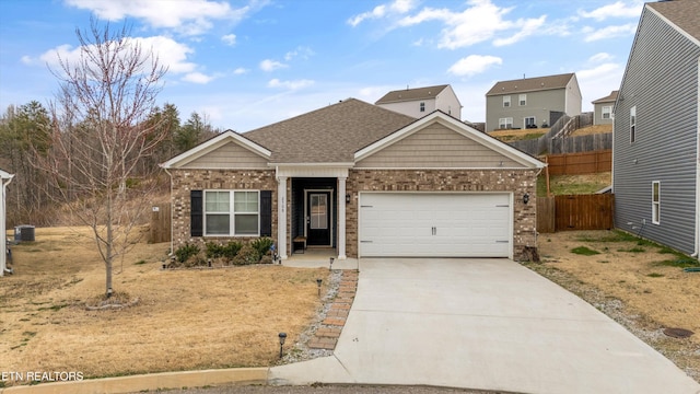 view of front of property featuring brick siding, fence, central AC, driveway, and an attached garage