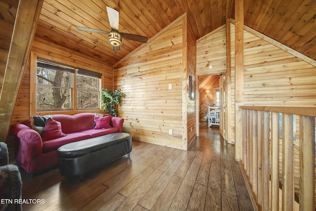 living area featuring hardwood / wood-style flooring, wooden walls, and wood ceiling