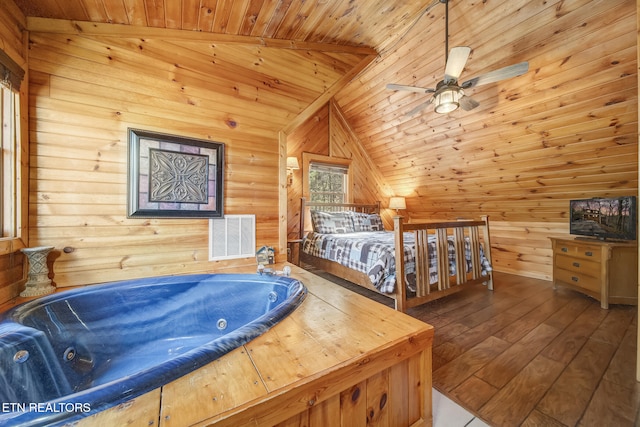 bedroom with visible vents, hardwood / wood-style flooring, wood ceiling, and vaulted ceiling