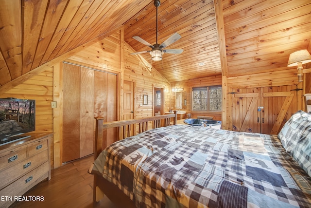 bedroom with wooden walls, wooden ceiling, lofted ceiling, and wood finished floors