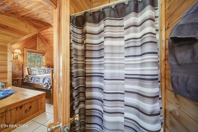 ensuite bathroom featuring vanity, wooden walls, tile patterned floors, wooden ceiling, and connected bathroom