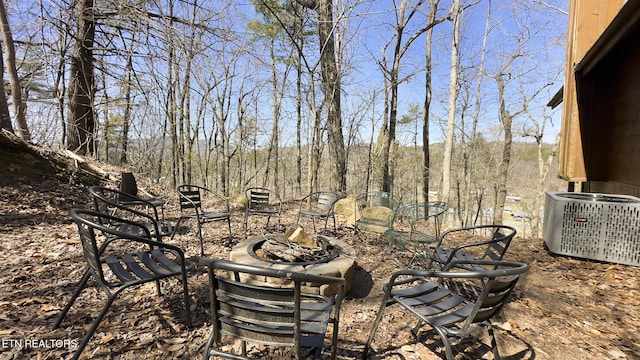 view of yard with cooling unit and a fire pit