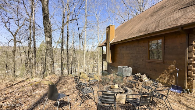 view of yard with cooling unit and a fire pit