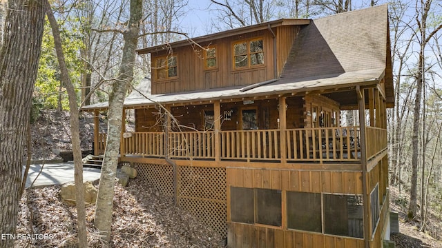 exterior space featuring a shingled roof