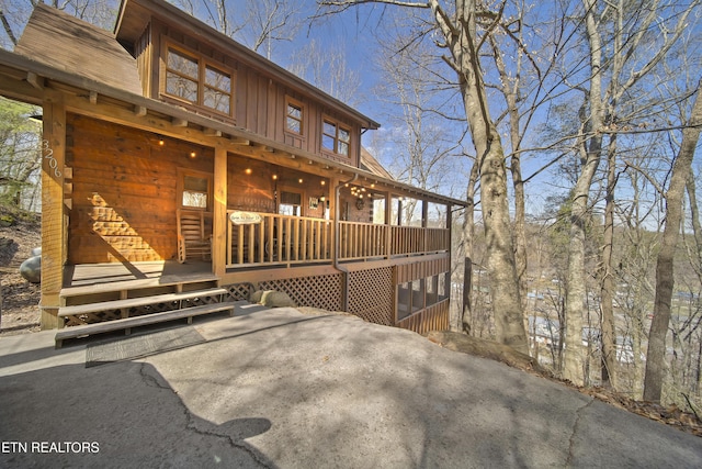 exterior space with board and batten siding and covered porch