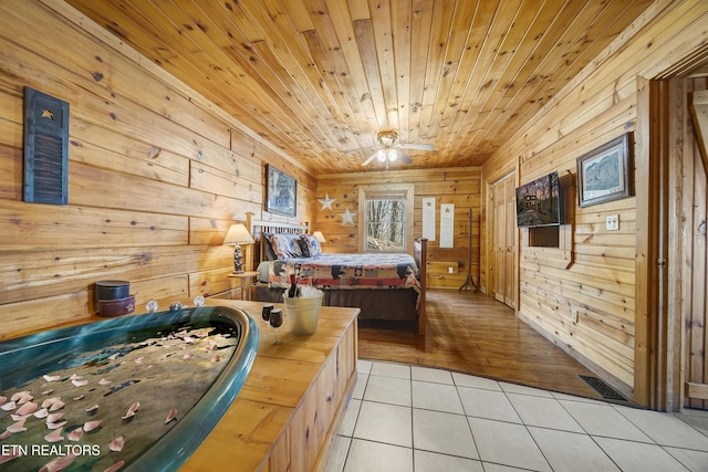 bedroom featuring wood ceiling, wood walls, visible vents, and light tile patterned flooring