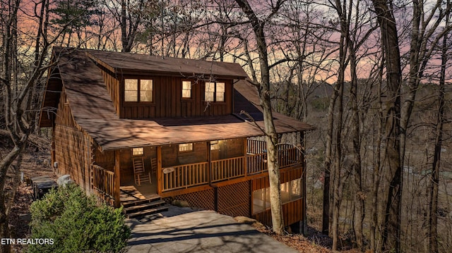 rustic home featuring board and batten siding and a porch