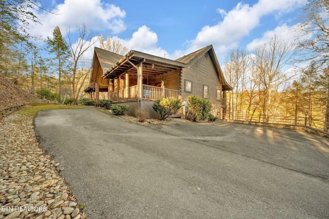 view of home's exterior with driveway and fence