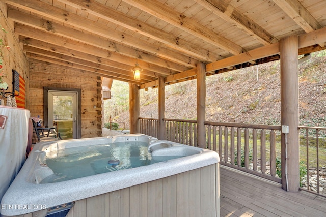 wooden deck featuring a hot tub