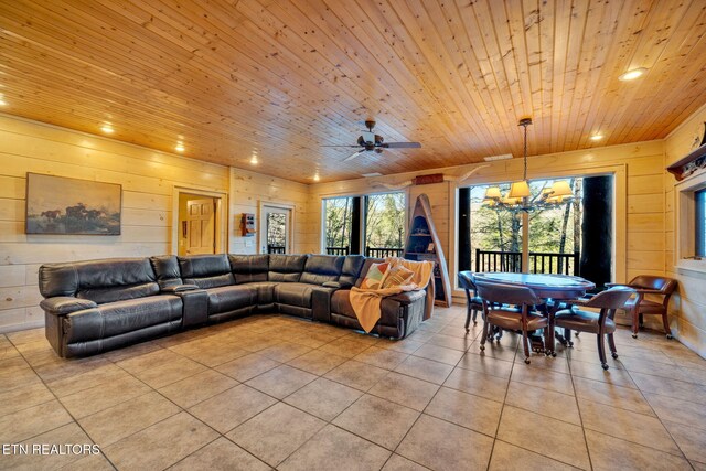 living room featuring recessed lighting, light tile patterned flooring, wood walls, wooden ceiling, and ceiling fan with notable chandelier