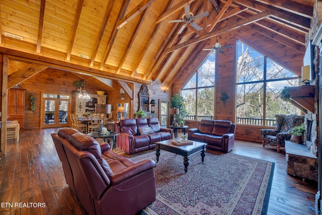 living room featuring hardwood / wood-style flooring, wood ceiling, wooden walls, and beamed ceiling