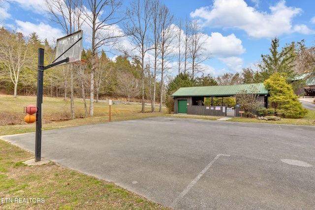 exterior space with a garage and community basketball court