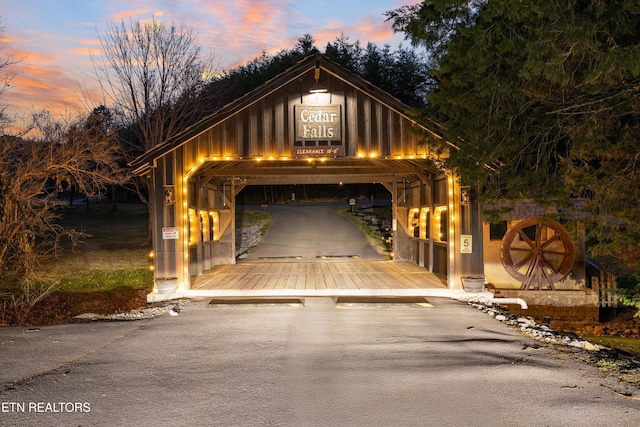 view of garage at dusk