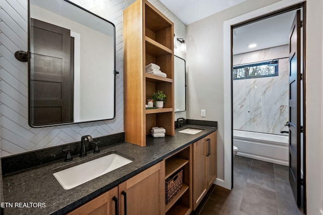 full bathroom featuring double vanity, toilet, shower / bathing tub combination, and a sink