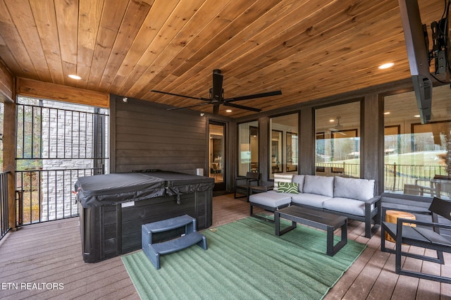 wooden deck with ceiling fan, an outdoor hangout area, and a hot tub