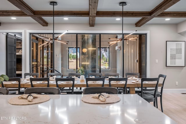 dining area featuring beamed ceiling, coffered ceiling, wood finished floors, baseboards, and a chandelier