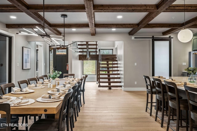 dining space with baseboards, coffered ceiling, stairs, light wood-style floors, and a barn door