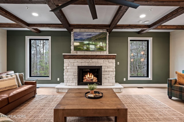 living area featuring a fireplace, baseboards, and coffered ceiling