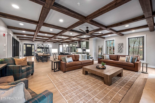 living room with beamed ceiling, light wood finished floors, and coffered ceiling