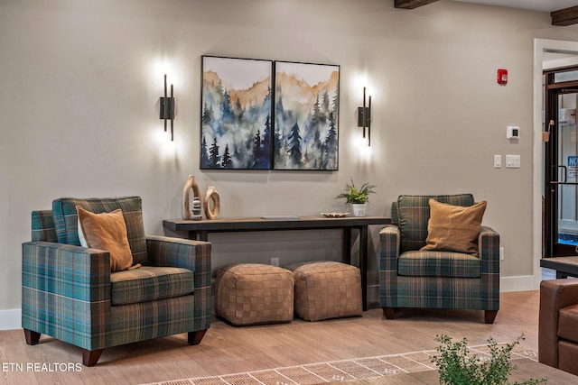 sitting room featuring baseboards and wood finished floors