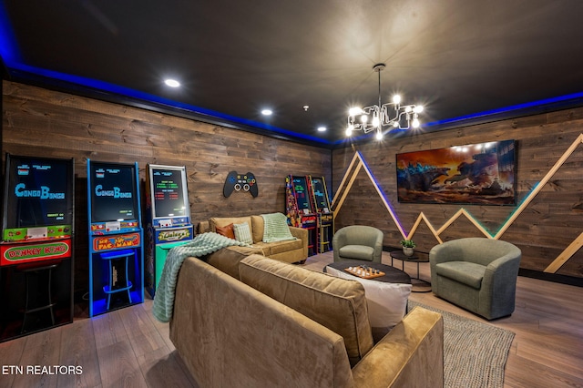 home theater room featuring recessed lighting, an inviting chandelier, wood walls, and hardwood / wood-style flooring