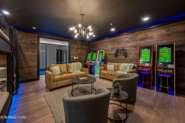 living room featuring a notable chandelier, wood finished floors, and recessed lighting