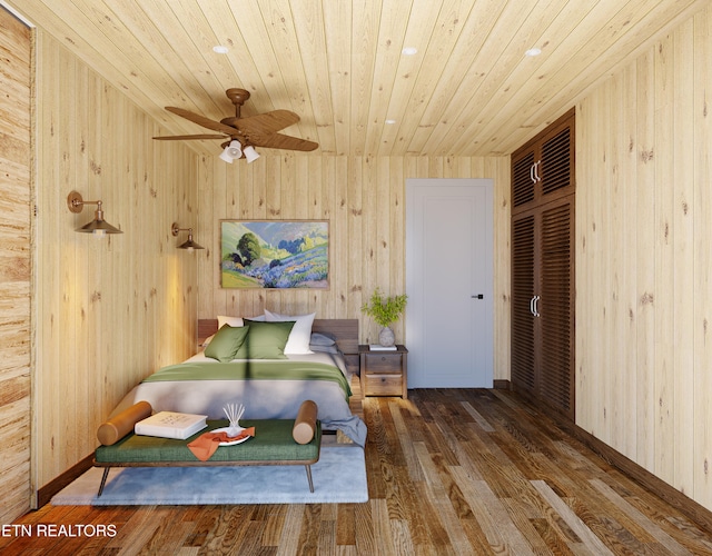 bedroom with wooden ceiling, wooden walls, wood finished floors, and a closet