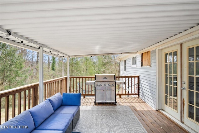 deck featuring an outdoor living space, french doors, and a grill